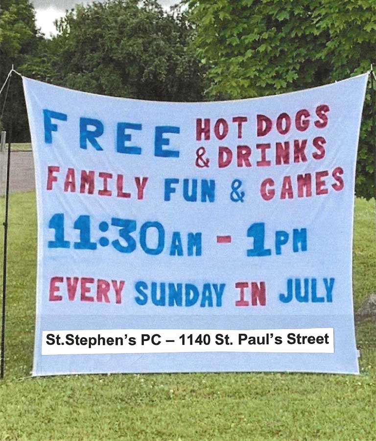 Hand painted sign reading: FREE Hot Dogs & Drinks